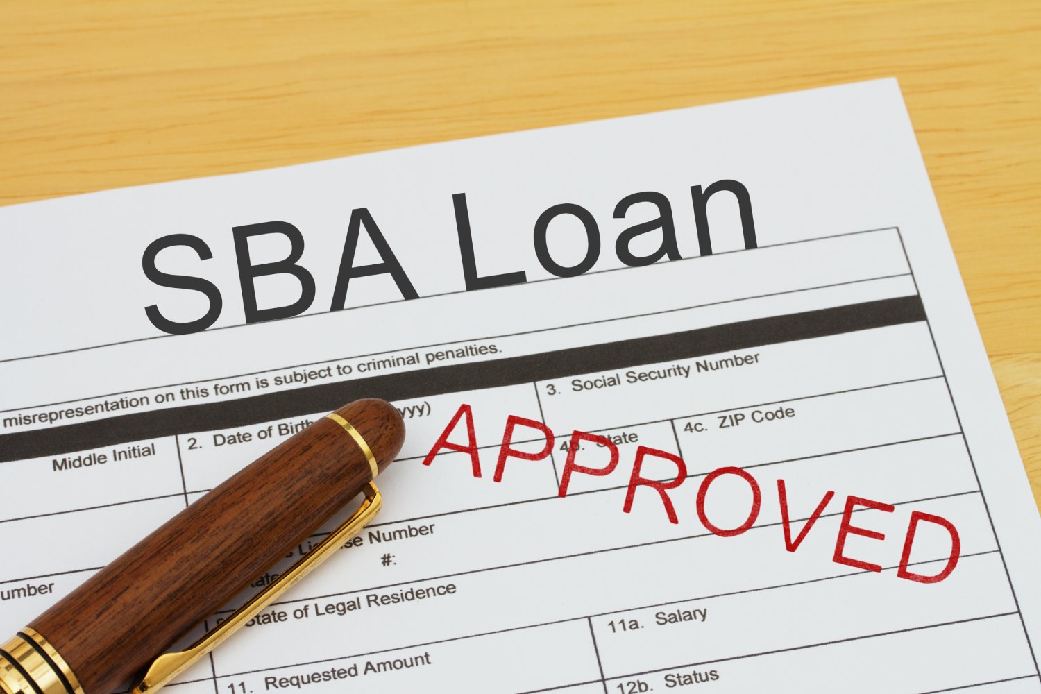 A sba loan application with the word approved on it.