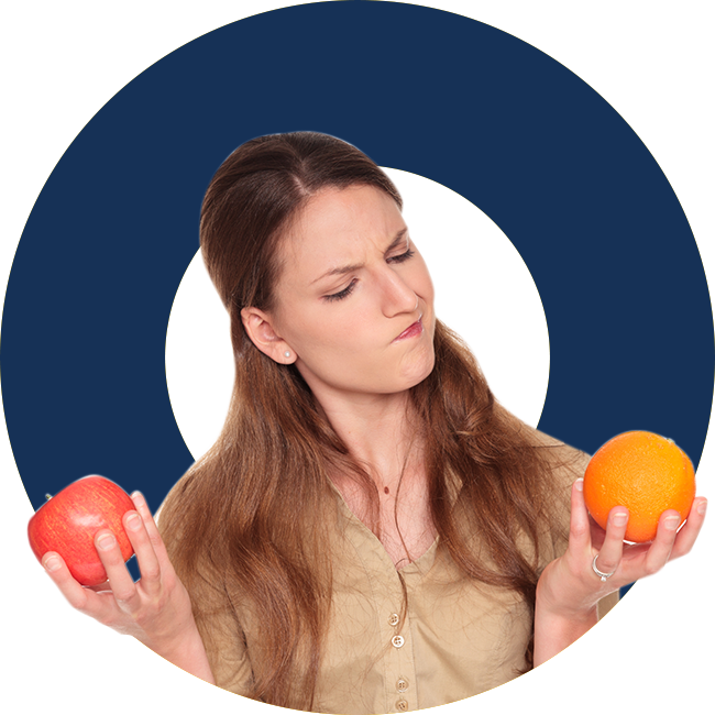 A woman holding an apple and orange in front of her face.